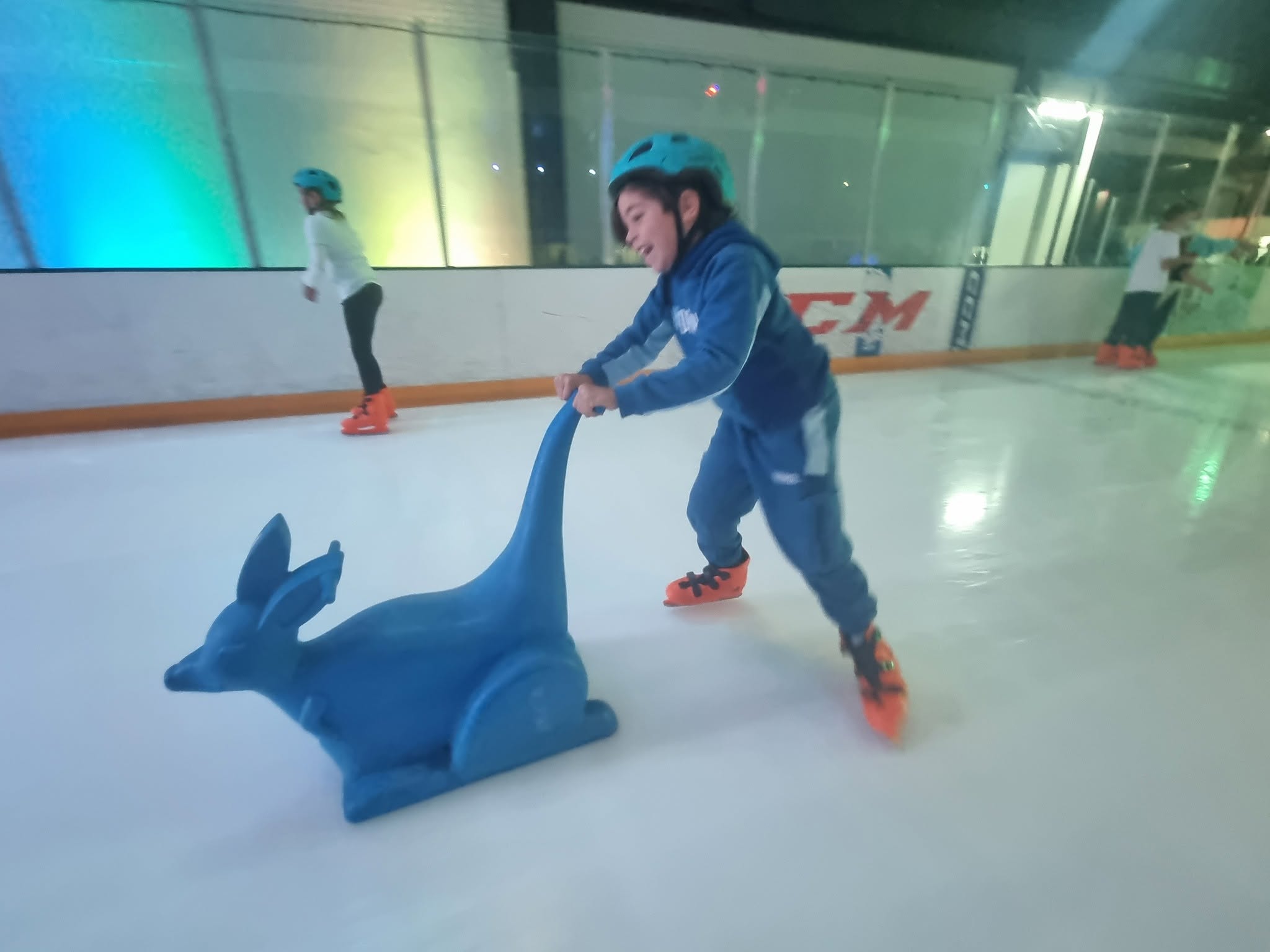 child ice skating with frame