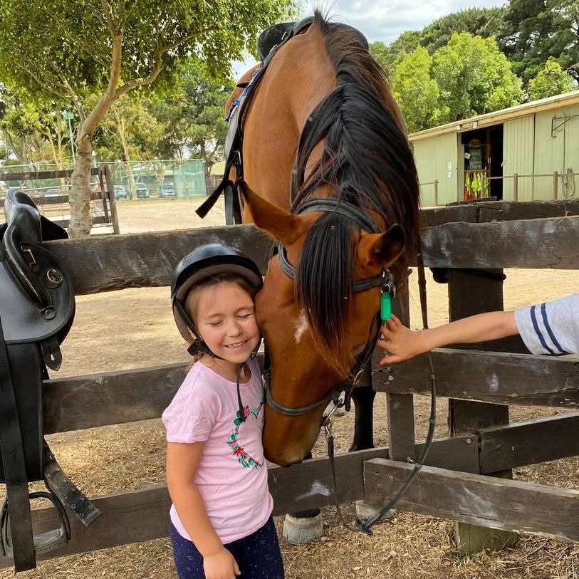 friendly horse cuddling child