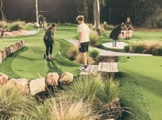 group playing mini golf