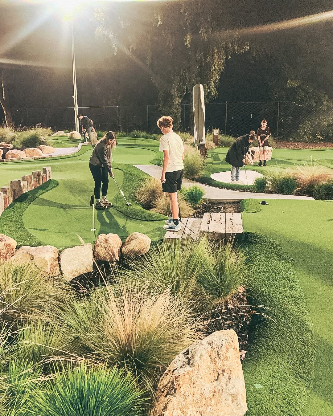 group playing mini golf