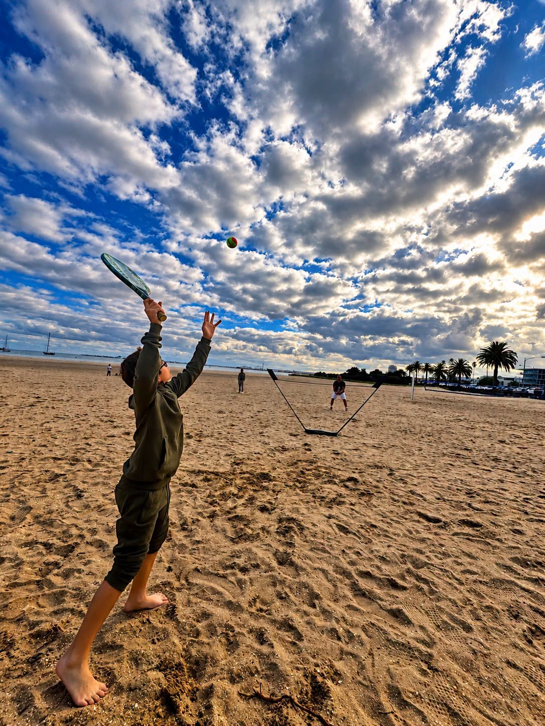 st kilda beach boy hitting ball